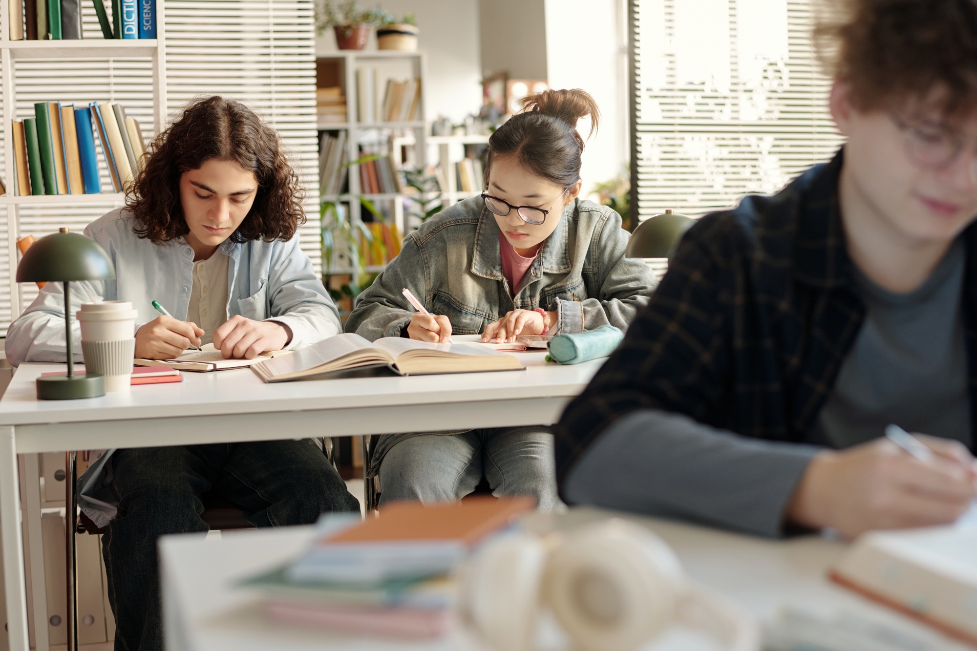 Two Students at Desk in College Class Working Preparing For Exams